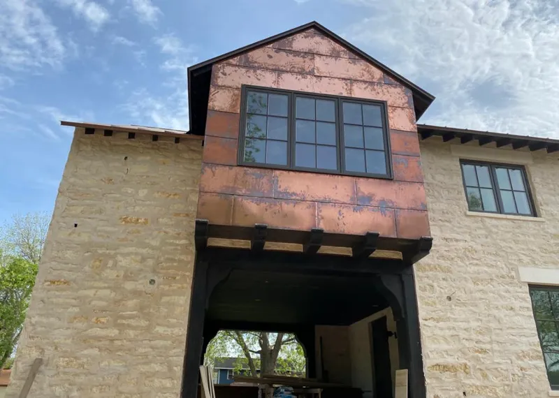 Copper metal panel facade on a stone building for Skylight Installation in Mankato